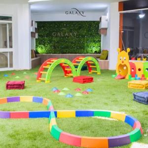 a room with many different types of play equipment on the grass at Dar GAMRA Luxury apartment with sea view in Hammamet Sud