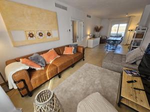 a living room with a brown couch and a table at ref. 67 casa alexandra in Zahara de los Atunes