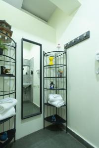a bathroom with a mirror and a shelf with towels at Nestay in Karnāla +41 photos