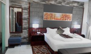a hotel room with two beds and a mirror at Limeridge Apartments in Mama +14 photos