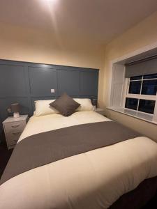 a bedroom with a large white bed with a window at Maloney's The Square Bed & Breakfast in Charlestown