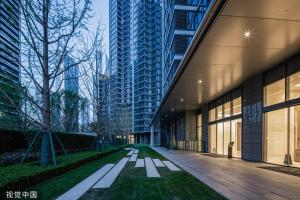 a walkway between two tall buildings in a city at Eastern Hub - Three Bedroom Apt in Xintiandi, 50m from Metro, Many Shops and Malls Surrounded in Shanghai