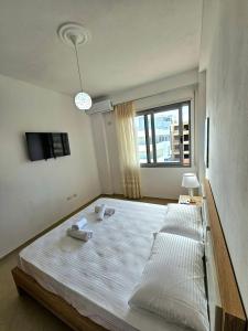 a bedroom with a large bed with two pillows on it at Vlora Beach Apartment Orikum in Orikum