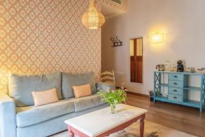 a living room with a couch and a table at Hotel Can Abril in Sóller