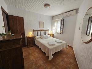 a bedroom with a bed with two towels on it at ref. 17 la colmena in Zahara de los Atunes
