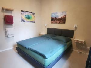 a bed in a room with paintings on the wall at Ferienwohnung Potsdam in Potsdam