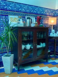 a cabinet in a room with a potted plant at Hostal Casa Alborada in Conil de la Frontera