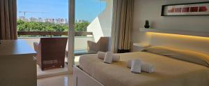 a bedroom with a bed and a balcony with a view at Golf & Mar - T2 Apartment in Vilamoura