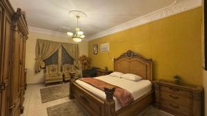 a bedroom with a large bed and a chair in it at شقة لين طيبة للعوائل Leen Taibah Ap. for family's in Al Madinah