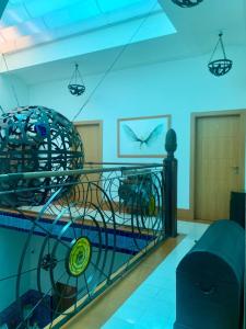 a room with a cage with a bird on the wall at Hostal Casa Alborada in Conil de la Frontera
