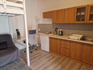 a small kitchen with a bunk bed and a desk at Surya Garden Retreat in Sběř