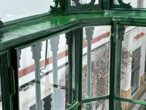 a reflection of a flag in a window at Hostal Casa Alborada in Conil de la Frontera