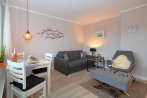 a living room with a couch and a table at Haus Alice - Widlak 34/6 in Westerland