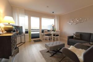 a living room with a couch and a table at Haus Alice - Widlak 34/6 in Westerland