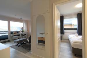 a room with a bed and a desk and a room with a mirror at Haus Alice - Widlak 34/6 in Westerland