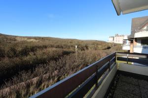 a view of a field from the balcony of a building at Haus Alice - Widlak 34/6 in Westerland