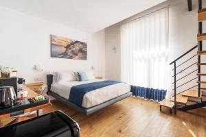 a bedroom with a bed and a large window at YourHome - Lidia Rooms & Suites in Sorrento +72 photos