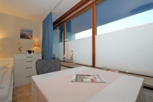 a room with a table with a magazine on it at Haus Sylter Welle 4-32 in Westerland (Sylt)