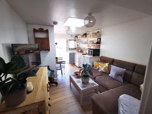 a living room with a couch and a table at Gorgeous Apartment near Bournemouth Beach in Bournemouth