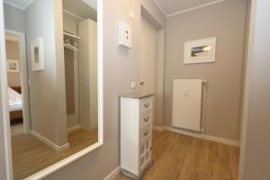 a bathroom with a mirror and a dresser in a room at Entennest am Dorfteich in Wenningstedt