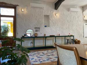 a living room with a table and a mirror at Traditional House, view on lake, yoga, sauna R4543 in Sorradile