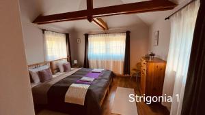 Posteľ alebo postele v izbe v ubytovaní Strigonia Apartman