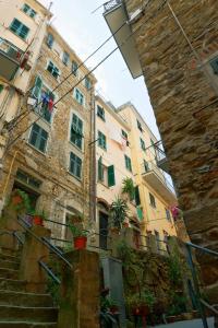a building with stairs and potted plants in front of it at Dai Ton in Riomaggiore