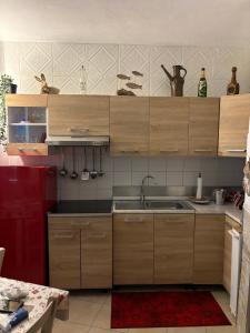 a kitchen with wooden cabinets and a sink at Il Quadrifoglio in Arenzano