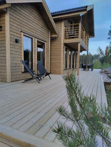 a wooden deck in front of a house at Lillelørdag Hytte - Stunning Holiday Home with Sauna in Vradal