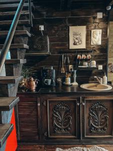 a wooden bathroom with a sink and a staircase at Casa Aristocrată - La noi la munte in Mătişeşti +14 photos