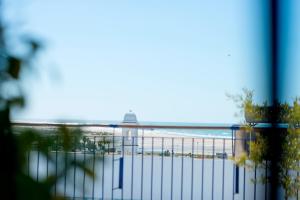 a view of a beach and the ocean from a balcony at Hostal Casa Alborada in Conil de la Frontera