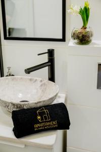 a bathroom sink with a stone bowl and a towel at Apartament BLISKO WSZĘDZIE in Ostrowiec Świętokrzyski