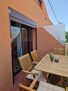 a wooden table and chairs on a patio at Almayate Playa Studio in Almayate Alto