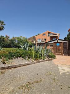 a house with a lot of plants in front of it at Almayate Playa Studio in Almayate Alto +11 photos