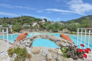 a swimming pool with a large swimming pool at Appartamenti dolores castle in Marina di Campo Airport