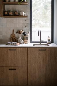 a kitchen counter with a sink and a window at Stillwood Retreat - Secluded Boutique Escape, Denmark, Western Australia in Denmark +24 photos