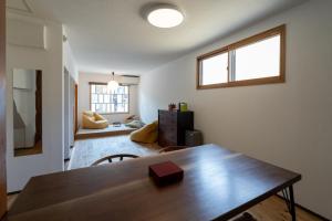 a dining room with a wooden table in a room at Cozy TAKAYAMA in Takayama +21 photos