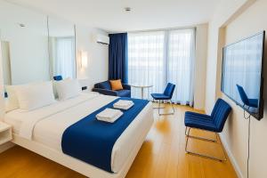 A bed or beds in a room at DOWNTOWN Centre in Batumi Aparthotel Orbi City N1