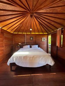 a bedroom with a bed in a wooden room at Yucan Ecostay Bedugul in Bedugul