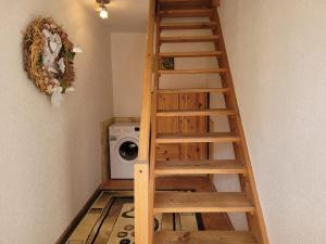 a wooden staircase in a laundry room with a washing machine at geraümige Wohnung im Grünen in Vollrathsruhe