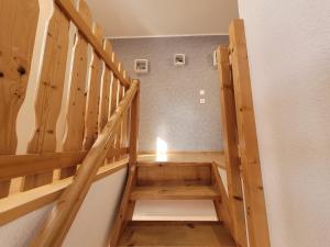 a wooden staircase with a candle in a room at geraümige Wohnung im Grünen in Vollrathsruhe