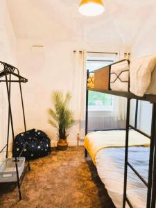 a bedroom with two bunk beds and a plant at 3BR House-Apartment-Free Parking-Manchester Airport in Manchester +9 photos