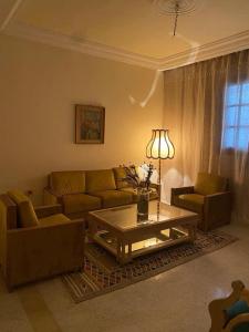a living room with a couch and a coffee table at Aziz house in Monastir