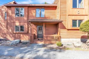 a wooden house with a door and a porch at Rumor 39O - Upgraded Townhome with Woodsy Views in North Creek