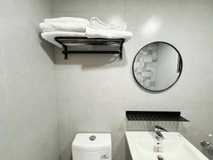 a bathroom with a sink and a mirror and a toilet at You Rou De Di Fang in Huxi +28 photos