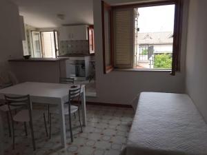 a kitchen with a table and chairs and a window at Bright Space in a Superb location in Praia a Mare