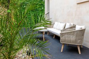 a patio with two chairs and a white couch at Silcox House Bath in Bath