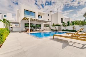 a swimming pool in the backyard of a villa at Periyiali Konnos Villas Beach Resort in Protaras