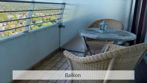 a small table and chairs on a balcony at Baltic Sea Deck 29 mit Meerblick in Timmendorfer Strand
