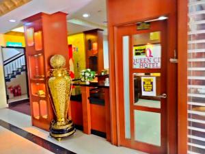 a trophy in the lobby of a hotel at Hotel O GHC Near Penang Street Art Formerly Queen City Hotel in George Town +39 photos